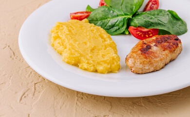 polenta with cutlet and cherry tomatoes with basil