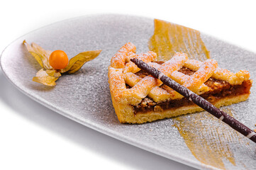 A slice of a pecan pie with ice cream and pecans