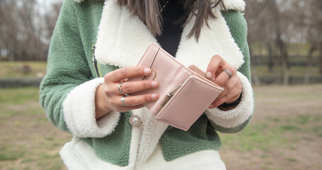 Young woman showing wallet. Fashion