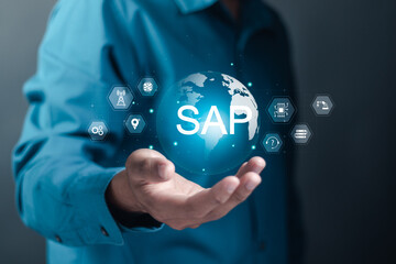 SAP, ERP enterprise resources planning system concept. Person holding globe with SAP word on virtual screen for business process automation software and management software.