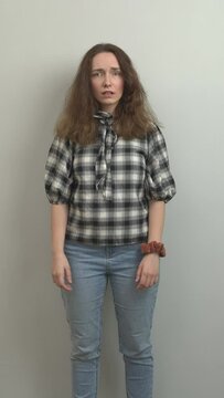 Disappointed girl being fed up with something, expressive hand gestures. Vertical video.