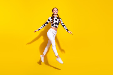 Full body profile portrait of gorgeous cheerful lady jump empty space isolated on yellow color background