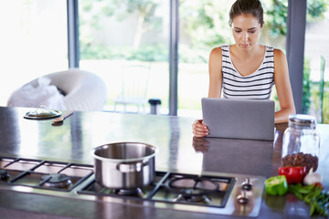 Woman, kitchen and laptop for food idea, female person and home on internet. Google it, browsing cooking recipes and social media, online search with technology or thinking of healthy meal to prepare