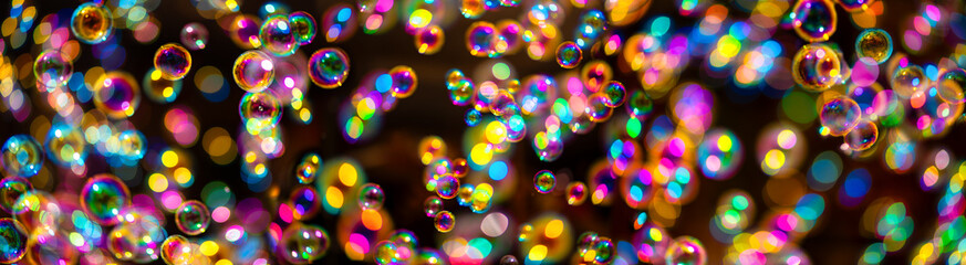 Colorful soap bubbles against a dark background. Colorful iridescent covers float together with...