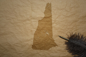 map of new hampshire state on a old paper background with old pen
