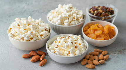 Mix of snacks. Variety of snacks such as nuts, chips and popcorn. - obrazy, fototapety, plakaty