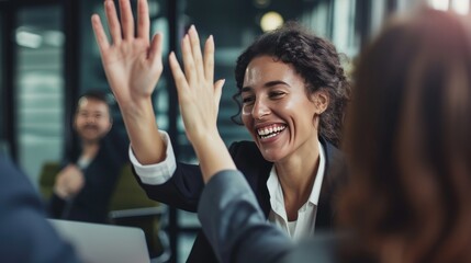 Businesswoman giving a high five to a colleague in meeting  - obrazy, fototapety, plakaty
