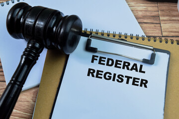 Concept of Federal Register write on paperwork isolated on wooden background.
