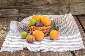 apricots in a basket on wooden table