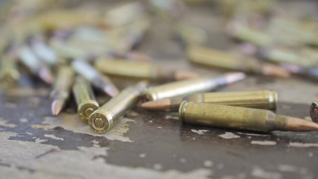 Gun Bullets on the ground, Passing Rows Of M-16 Gun Ammunition. Military ammunition before going to war. M16 rifle magazine ammo ready for combat. war zone