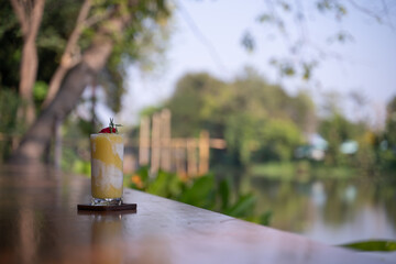 Mango and coconut smoothie on a table outdoors