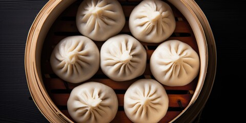 Fototapeta na wymiar Top view of a gray background with a Bamboo steamer containing a Korean street food: Pyanse steamed bun.