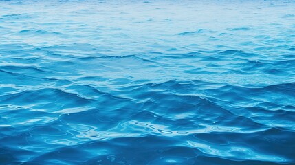 Calm blue waves dominate the frame, perfect for themes of peace and serenity, ideal as a soothing background or for wellness-related content, with a large area for text.