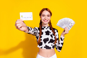 Photo of cheerful excited woman wear cow skin print top choosing credit card instead cash isolated...