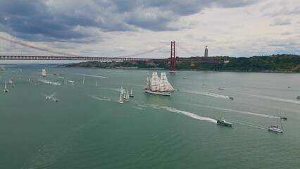 Tourist yachts sailing river at gloomy day aerial view. Lisboa marine cityscape