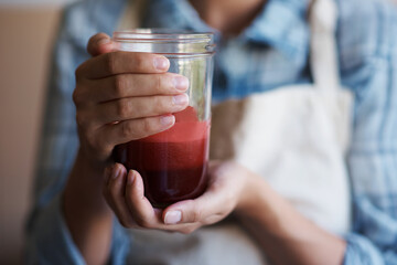 Hands, glass and juice with kitchen, closeup and person with smoothie for health and wellness....