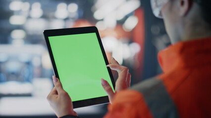 Technician swiping mockup tablet checking data on industrial facility close up.