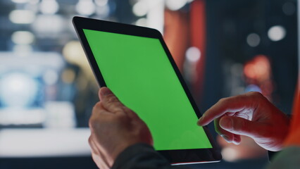 Engineer hands working green screen tablet computer in factory workshop close up - Powered by Adobe