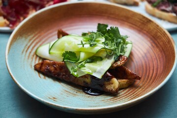 A dish of fresh vegetables and potatoes. A festive table. A dish in a restaurant.