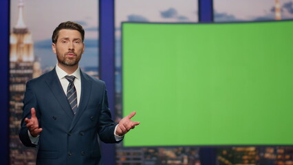 Breaking news reporter talking in front chroma key monitor tv studio close up. 
