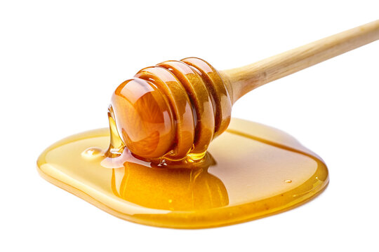 honey dripping from a wooden dipper