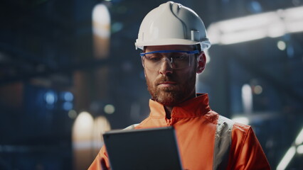 Skilled technician inspecting production industrial facility with tablet closeup - Powered by Adobe