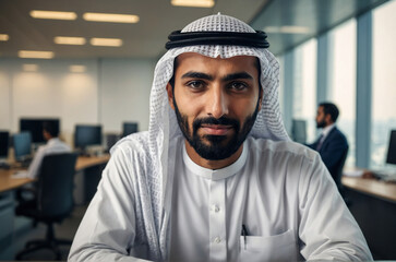 Arabic man in a hood with beard, in office