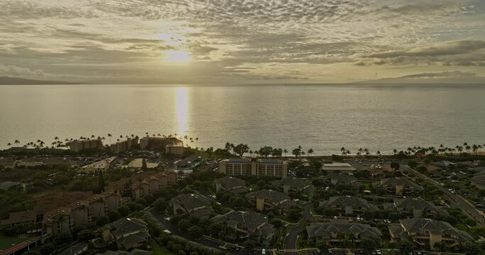 Kihei Maui Hawaii Aerial v2 Hawaiian coastal landscape, drone flyover residential areas capturing Kamaole Beach Park and oceanscape with golden sunset views - Shot with Mavic 3 Cine - December 2022