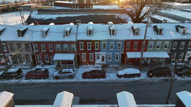 American city housing during winter sunset with snow. Aerial truck shot.