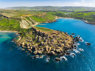 Drone view of maltese bay and beach. Spring, green countryside. Ghain Tuffieha, Maltese island