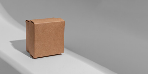 Kraft carton box cover of square shape, cardboard package. Banner background