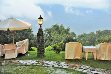 Table and chairs in rain, Elgin Mount Pandim Hotel, Pemayangtse, Pelling, Sikkim, India, Asia