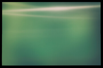 Abstract blurry green background in a black frame and light horizontal lines. - 753568780