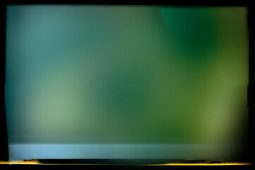 Abstract blurry green background in a black frame and light horizontal lines. - 753568785