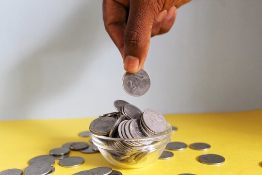 Hand putting a coin on pig saving. a pile of coins, business, investment, finance, and Money Saving for future concepts, save money.