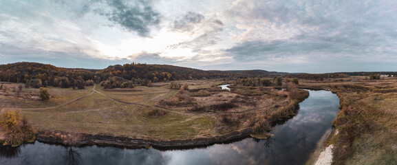 Aerial panorama on river curve in autumn valley