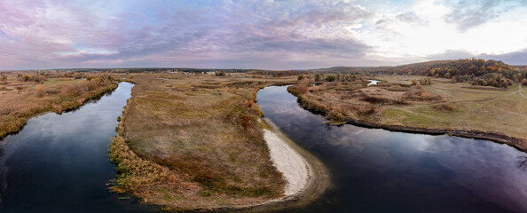 Aerial panorama on river curve in autumn valley