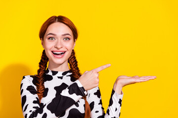 Photo of excited funky woman wear cow skin top holding arm showing finger empty space isolated...