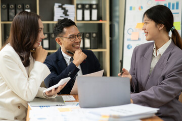 Asian business presents to explain the graph work on the whiteboard. Consulting, discussing, exchanging knowledge.