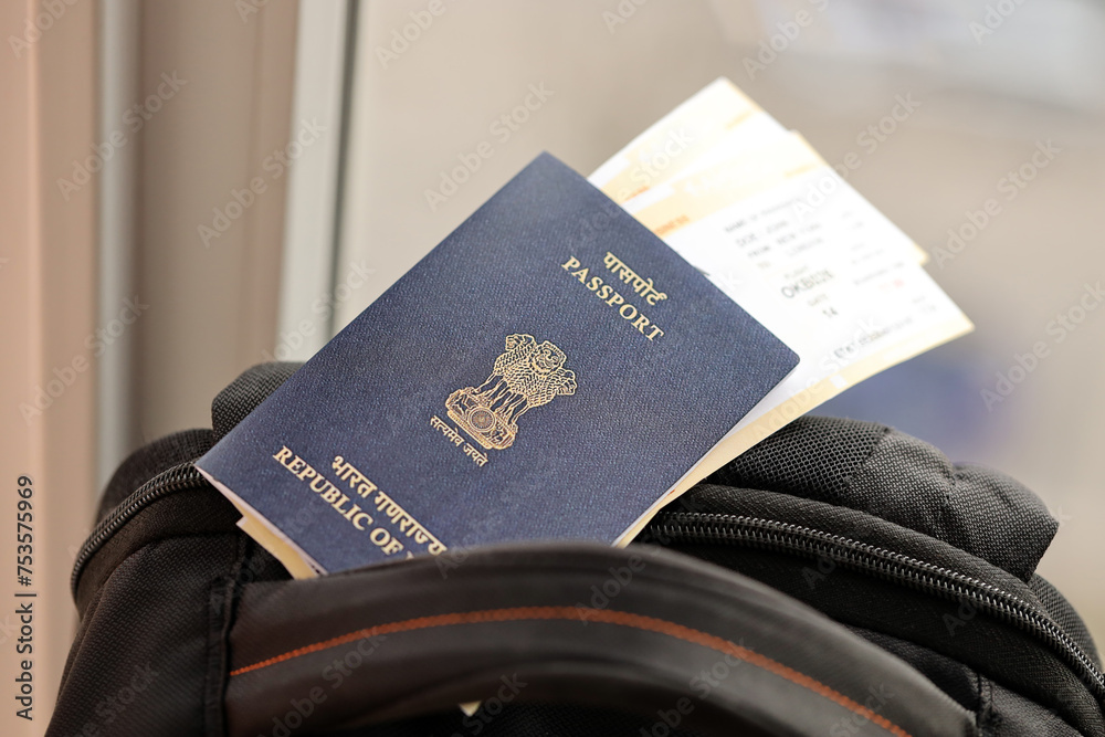 Wall mural Blue Indian passport with airline tickets on touristic backpack close up. Tourism and travel concept