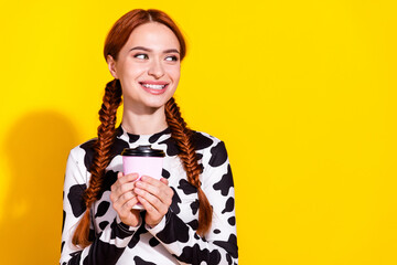 Photo of pretty dreamy woman wear cow skin print top drinking tea looking empty space isolated yellow color background