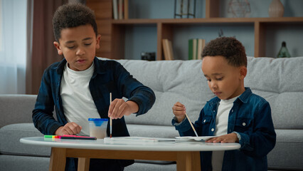 Two African American children kids school boys ethnic little friends siblings brothers drawing...