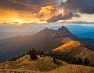 Mountain landscape at sunset sunrise with yellow cloud sky