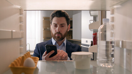 Point of view POV inside refrigerator Caucasian businessman employer man open fridge empty shelves...