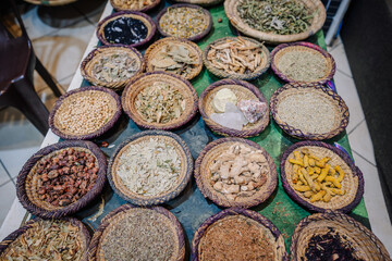 Agadir, Morocco - February 25, 2024 - Baskets filled with various herbs and spices displayed on a...