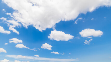 Panoramic view of clear blue sky and clouds, Blue sky background with tiny clouds. White fluffy clouds in the blue sky. Captivating stock photo featuring the mesmerizing beauty of the sky and clouds.