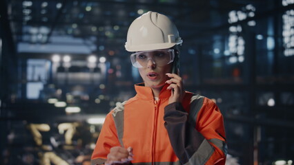 Engineer have work call at modern factory facility in protective hardhat closeup