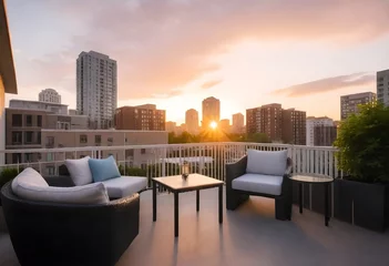 Foto op Canvas Sunset view from a high-rise balcony with two outdoor sofas and a city skyline in the background  © Muhammad