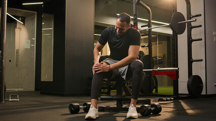 Latino American man feel bad ache knee pain painful cramp injury leg joint after workout exercise...