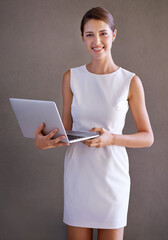 Business, typing and woman with laptop, portrait and employee on a studio background. Person,...